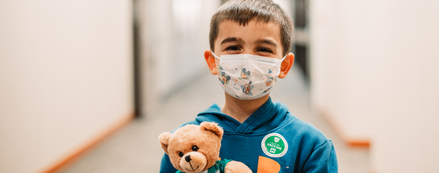 Masked Child at Vaccination Clinic